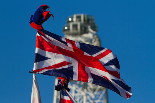 british flag with a hat (souvenir) in national colors with the London Eye in the background