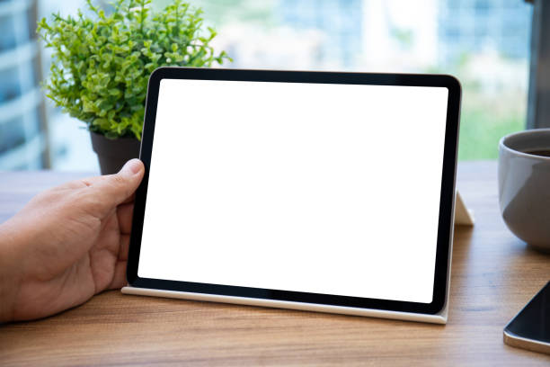 istock male hand holding computer tablet with isolated screen in office 1380715130