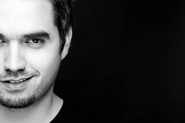 istock Half Face Of A Smiling Handsome Young Guy 138071567
