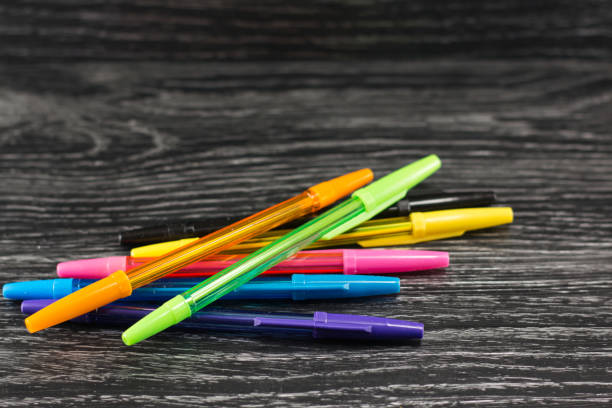 colorful pens on a black table stock photo