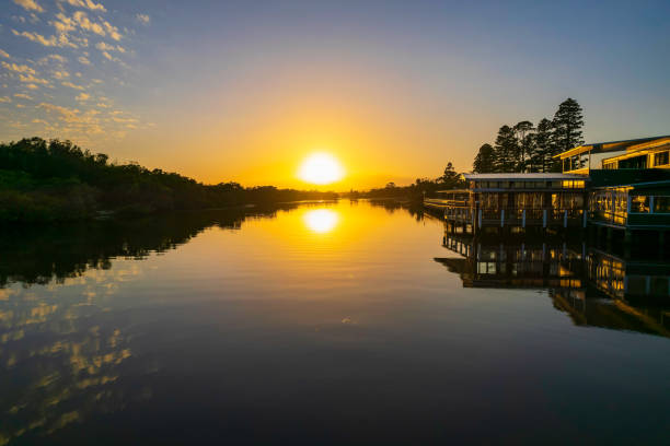 istock Sunrise waterscape with scattered clouds and reflections 1380747812