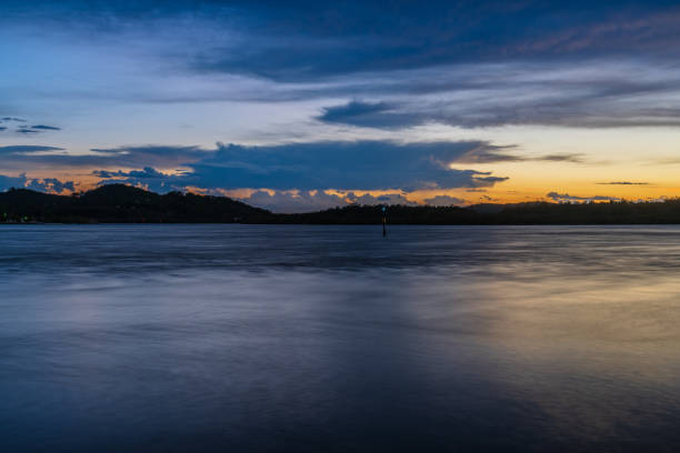 istock Sunrise by the bay with stratocumulus clouds 1380747814