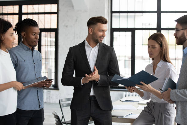 istock Diverse employees discuss business ideas in team meeting 1380764334