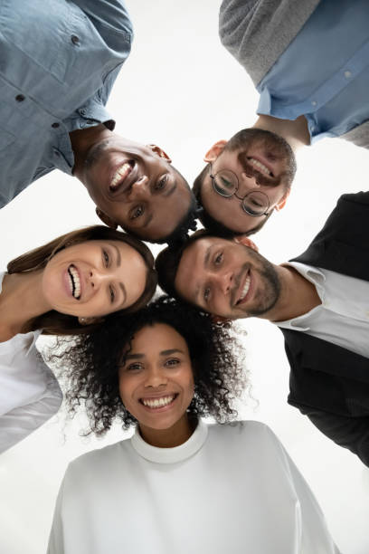 istock Low angle portrait of smiling diverse employees together 1380764396