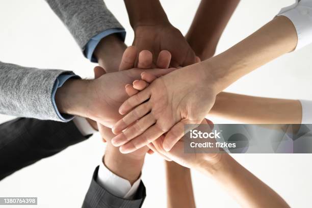 Close Up Of Diverse People Stack Hands For Shared Success Stock Photo - Download Image Now