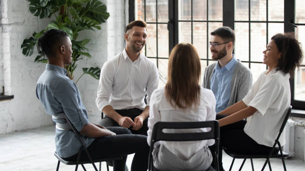 istock Smiling diverse people engaged in group counseling together 1380764415