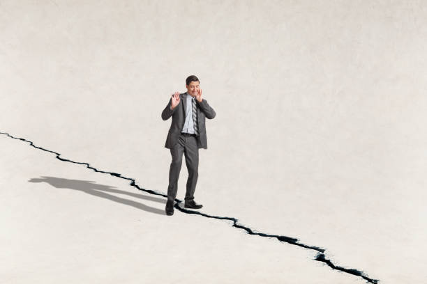 istock Man Stepping Tentatively On Other Side Of Crack 1380798748