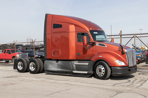 Indianapolis - Circa March 2022: Kenworth Semi Tractor Trailer Trucks on display at a dealership. Kenworth is owned by PACCAR.