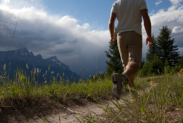istock Man walks along mountain trail, oncoming storm 138080508