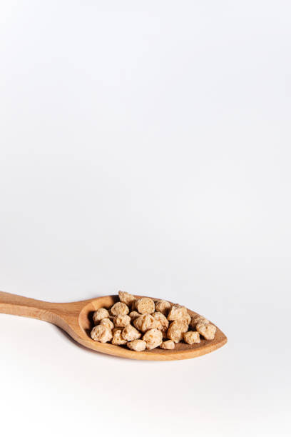 istock Wooden spoon filled with thick textured soy beans. 1380807086