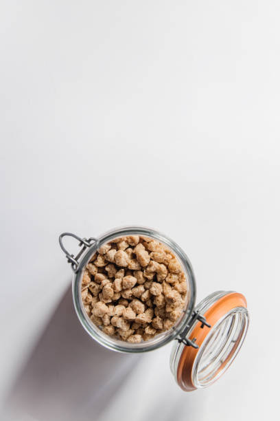 istock Top view of a glass jar filled with thick textured soy beans. 1380807088