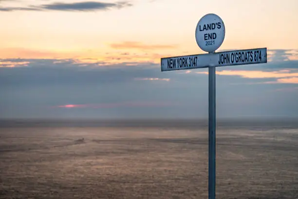 A summer sunset.The iconic signpost,established in the 1950s,a legendary Cornish icon,popular touristic landmark,used as starting and finishing point for Lands End to John O Groats charity walks..