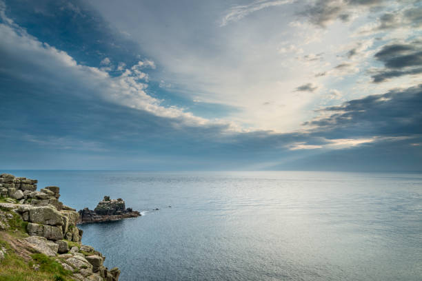 At the British mainland's westernmost point,a calm and peaceful Atlantic Ocean,high pressure,summer season clouds,a beautiful tranquil scene,looking west towards America.