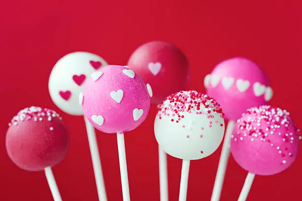 Cake pops decorated with sugar hearts and sprinkles