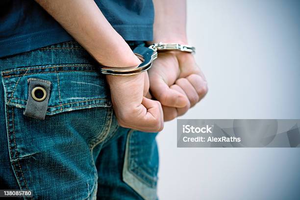 Teenager Under Arrest Stock Photo - Download Image Now - Teenager, Adolescence, Handcuffs