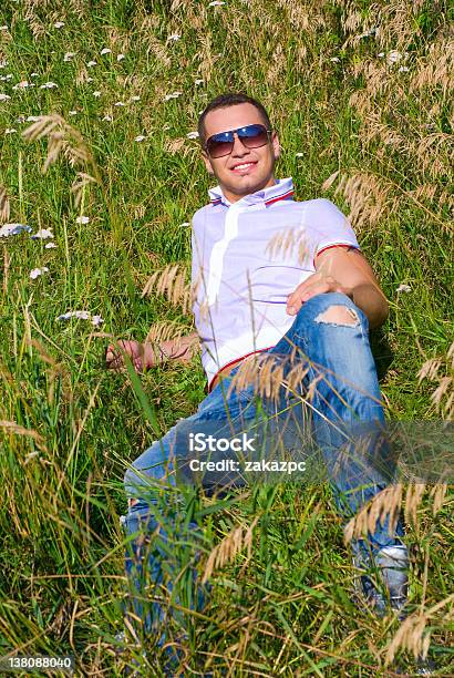 Happy Young Man In Grass Stock Photo - Download Image Now - 20-24 Years, 20-29 Years, Adult