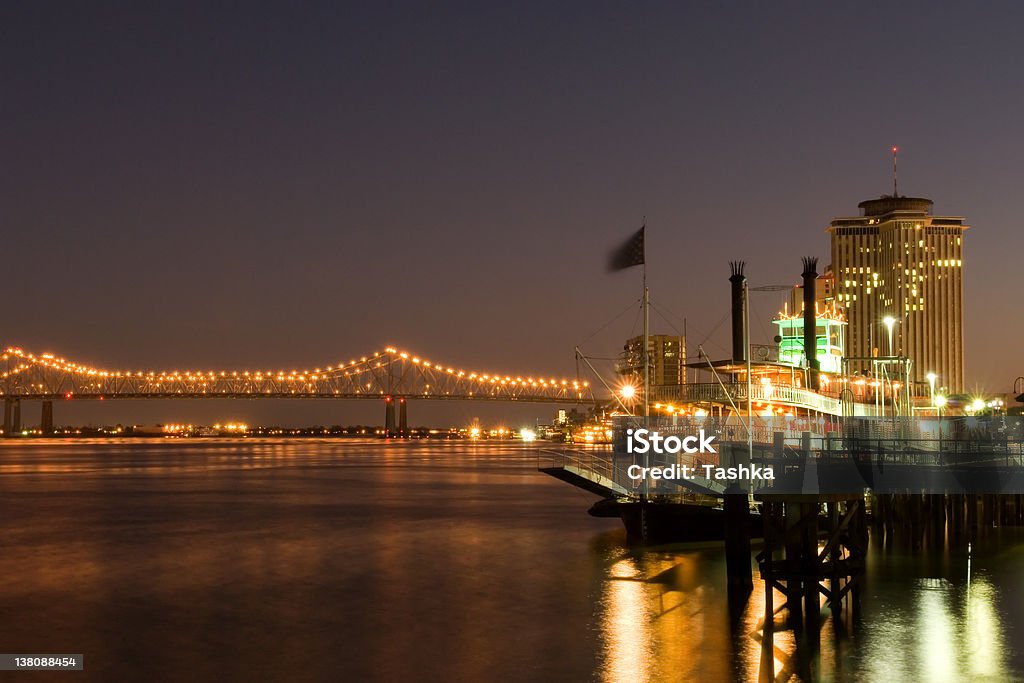 New Orleans waterfront Hotels and bridge over Mississippi river at dusk New Orleans Stock Photo
