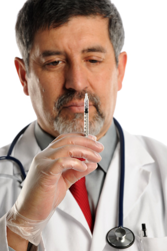Hispanic doctor holding syringe