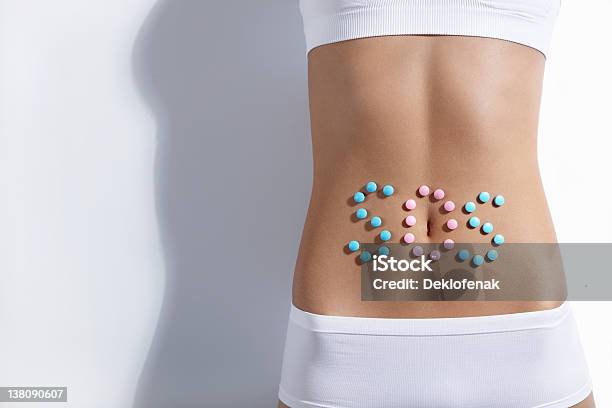 Female Stomach With The Letters Sos In Blue And Pink Circles Stock Photo - Download Image Now