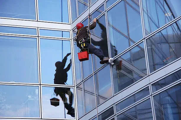 Window cleaner working on a row of windows.