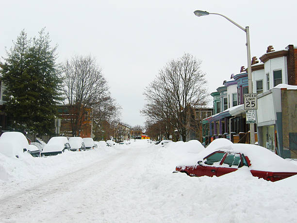 istock Red Snow Covered Car on City Street 138091404