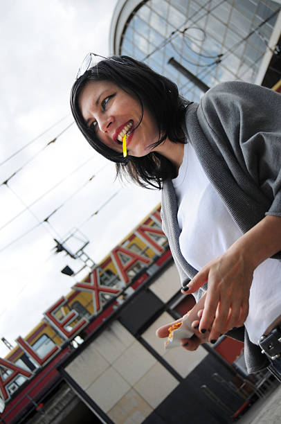 istock tourist eating currywurst at Alexanderplatz Berlin Mitte Germany 138091560