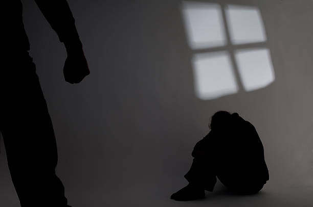 Shadow of a person in the corner hiding from abuse symbolic picture of violence at home victims stock pictures, royalty-free photos & images
