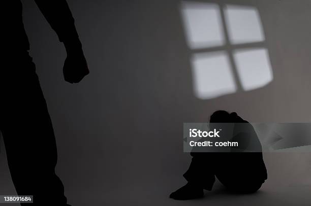 Shadow Of A Person In The Corner Hiding From Abuse Stock Photo - Download Image Now - Sexual Assault, Domestic Violence, Violence