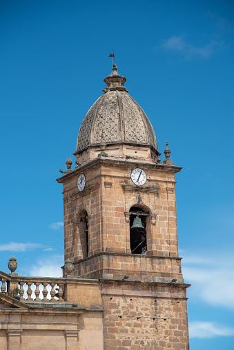 Bell tower with clock of the church in the main square of the city of Tunja. Colombia.