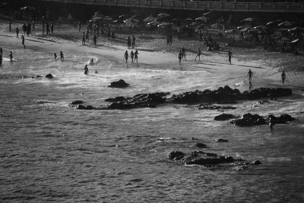 Salvador, Bahia, Brazil - September 19, 2021: Large group of people on the beach in a bright sunny day in the city of Salvador in the Brazilian state of Bahia.