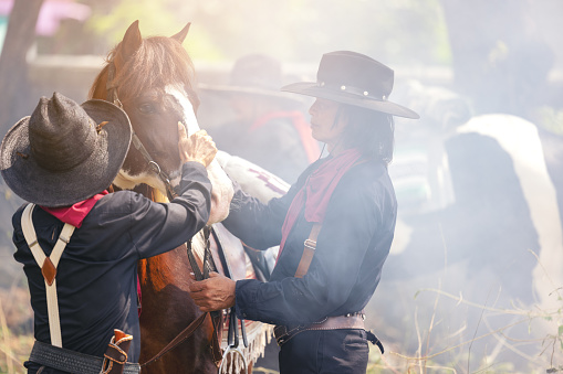 On the countryside, a cowboy walks his horse. Nature notion of freedom.