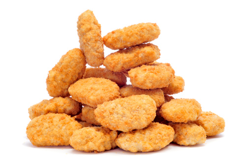 a pile of chicken nuggets on a white background