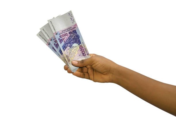 istock Fair hand holding 3D rendered 10000 West African CFA notes isolated on white background 1380957934