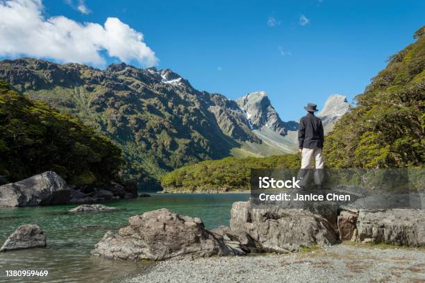 A Man Standing On The Rocks By Lake Mackenzie On Routeburn Track One Of The Great Walks Of New Zealand Stock Photo - Download Image Now