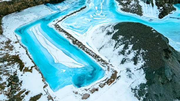 istock Turquoise colored frozen water in the quarry 1380960373