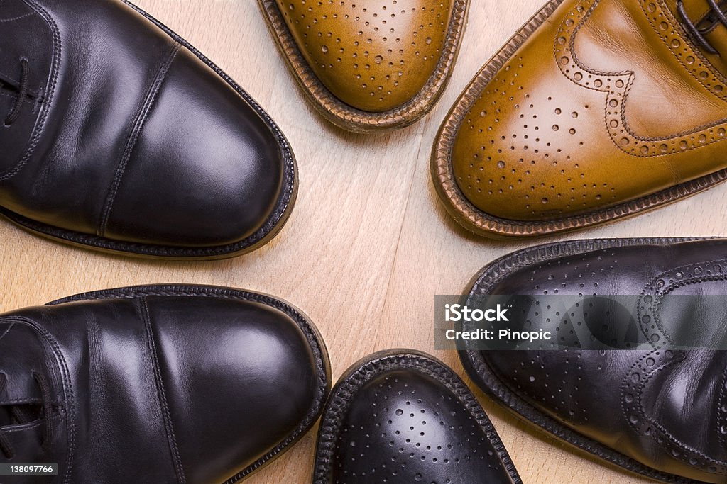 Business meeting  - Six  shoes together Six business shoes together on a wooden floor. Brogue Stock Photo