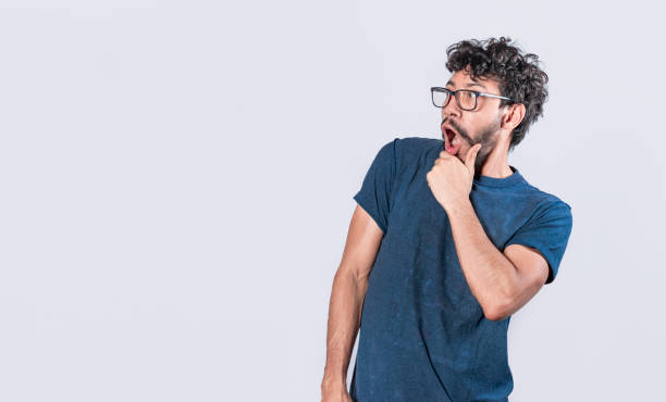 istock Amazed young man with hand near open mouth, man looking aside with face scared expression, surprised guy on isolated background 1380979146