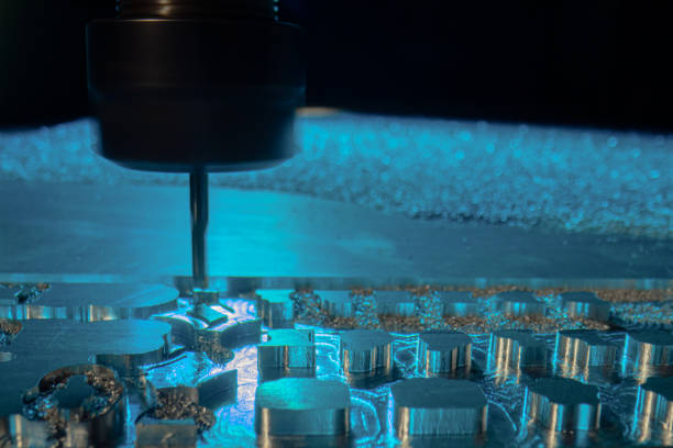 istock Metalworking CNC milling machine. Drilling steel. A drilling machine processes metal, cuts out a shape. Modern processing technology of detail. Making industrial details close up in blue light 1380980471
