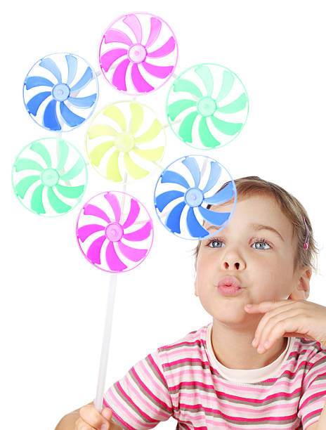 istock Little girl blowing on toy windmill 138098225