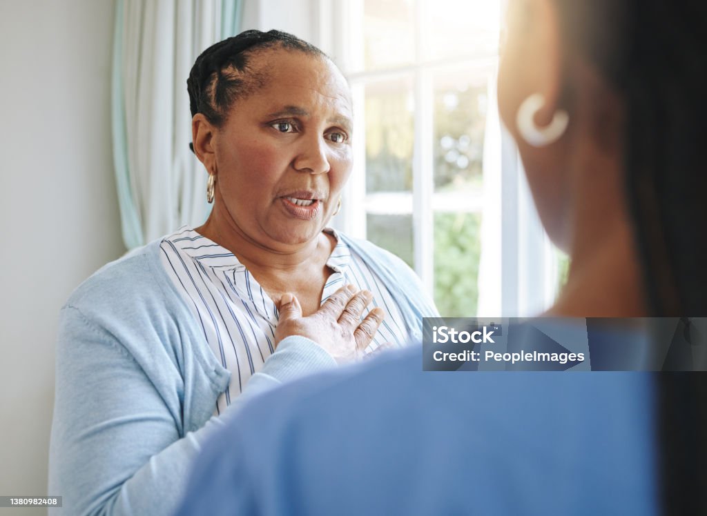 Shot of a nurse speaking to her female patien I'm stressing it, really Talking Stock Photo