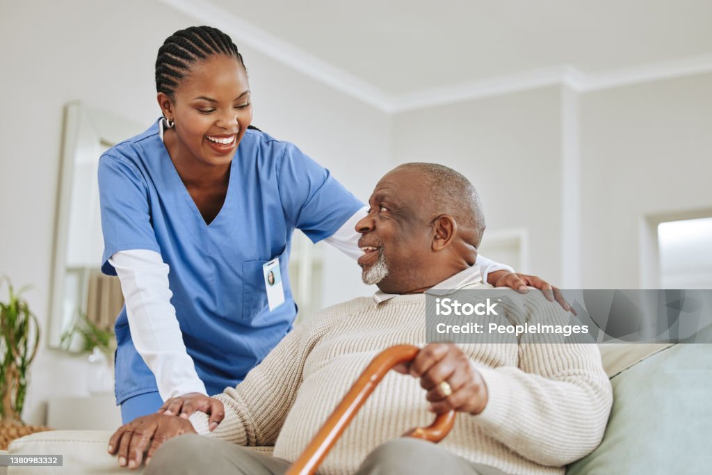 Shot of a nurse speaking to her male patient Getting old is inevitable Nurse Stock Photo