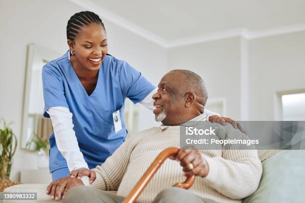 Shot Of A Nurse Speaking To Her Male Patient Stock Photo - Download Image Now - Nurse, Senior Adult, Healthcare Worker