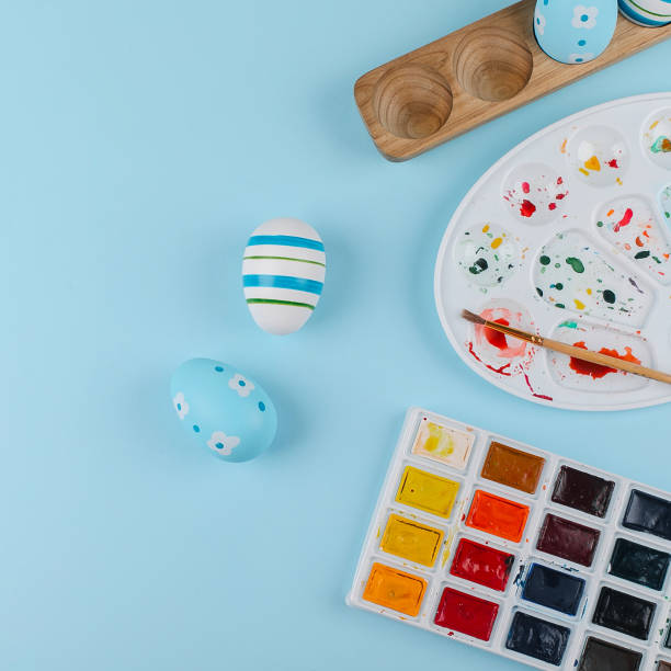 istock Crop image of flat lay composition with easter eggs and paints 1380985623
