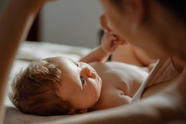 istock Mother and baby snuggles after nursing. 1380989414