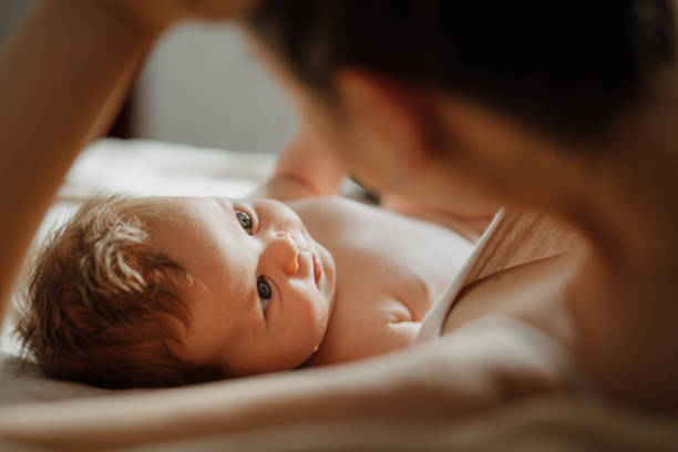 istock Mother and baby snuggles after nursing. 1380989431