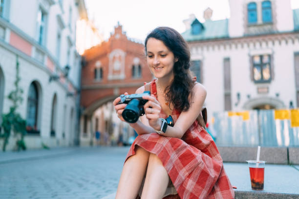 Tourist woman with camera exploring Europe