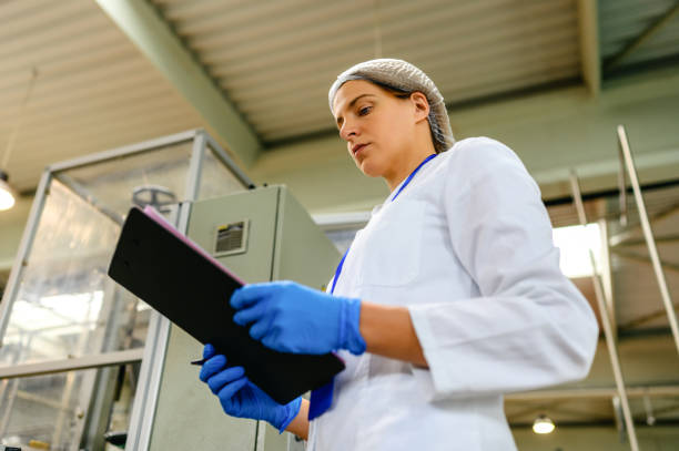istock Female engineer working on maintenance in bottling plant 1381003570