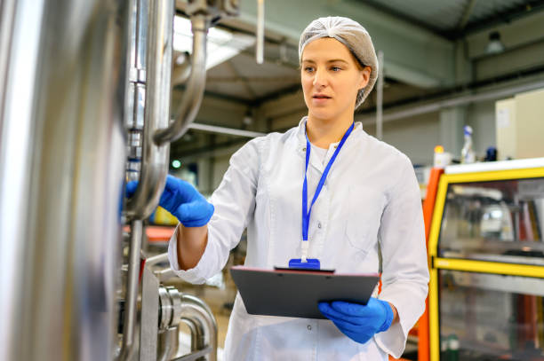 istock Female engineer working on maintenance in bottling plant 1381009251
