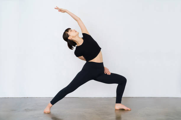 istock Woman doing yoga (warrior pose) 1381012365