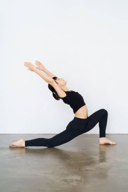 istock Woman doing yoga (crescent pose) 1381015620